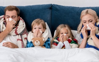 A family in bed together, sick with flu