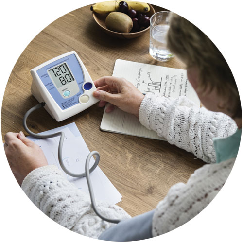 Woman checking her own blood pressure Woman checking her own blood pressure