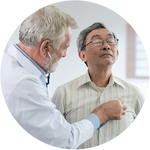 Doctor listens to heart of older male patient Doctor listens to heart of older male patient