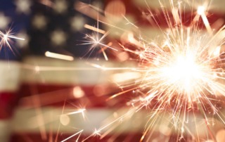 Sparklers against a United States flag background