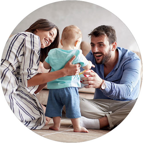 Young mother and father play with their infant Young mother and father play with their infant
